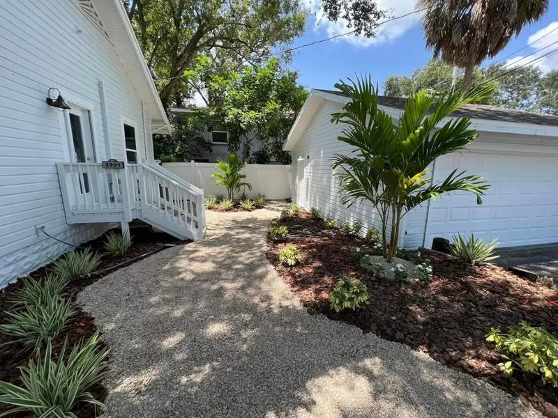 A beautifully designed residential garden with structured flowerbeds and specimen plantings